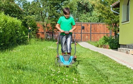 child mowing the lawn