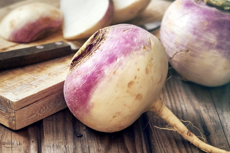 close up for raw organic turnips on rustic wooden surface