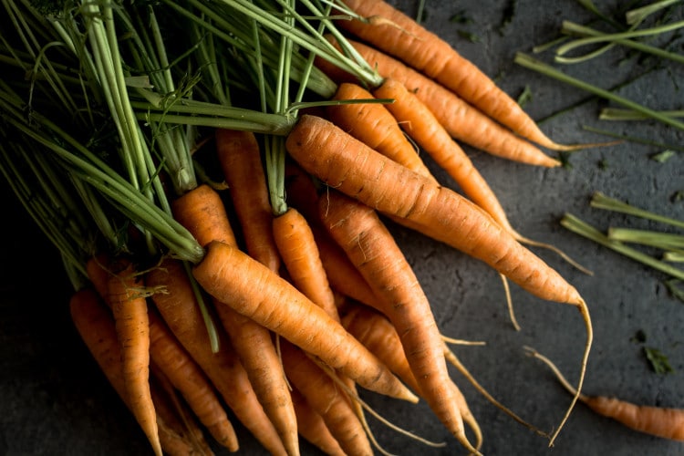 Oragnic nantes carrots on a dark rustic background