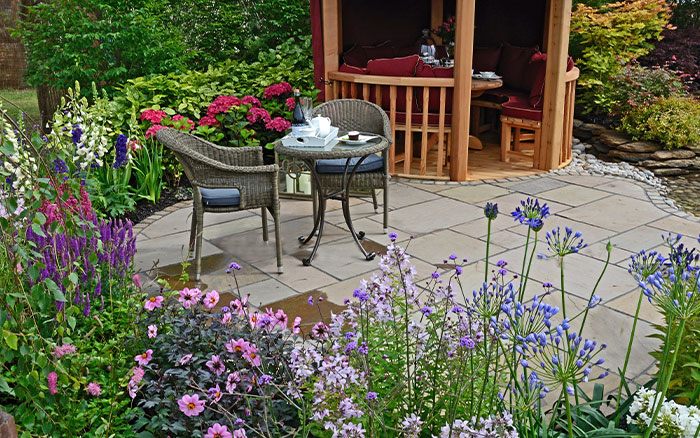 A patio and seating area in a garden